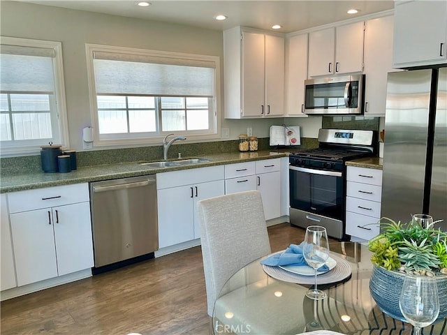 22801 Nolan St, Lake Forest, CA 92630 - kitchen featuring stainless steel appliances, white cabinets, recessed lighting, dark wood-type flooring, and dark countertops