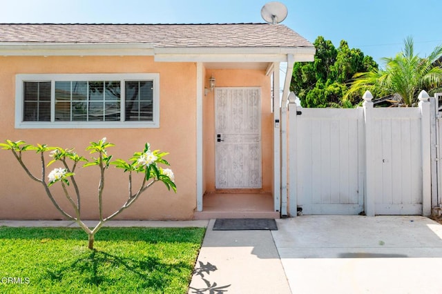 9818 Firebird Ave, Whittier, CA 90605 - property entrance with a gate, roof with shingles, and stucco siding