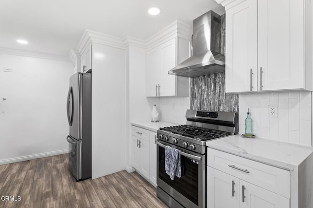 9818 Firebird Ave, Whittier, CA 90605 - kitchen with stainless steel appliances, wall chimney range hood, backsplash, white cabinetry, and wood finished floors
