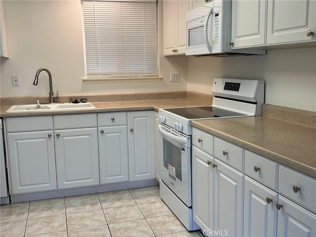 2268 Via Puerta Unit O, Laguna Woods, CA 92637 - kitchen with white appliances, light tile patterned floors, and white cabinets
