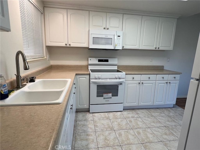 2268 Via Puerta Unit O, Laguna Woods, CA 92637 - kitchen featuring white appliances, white cabinets, light countertops, and light tile patterned floors