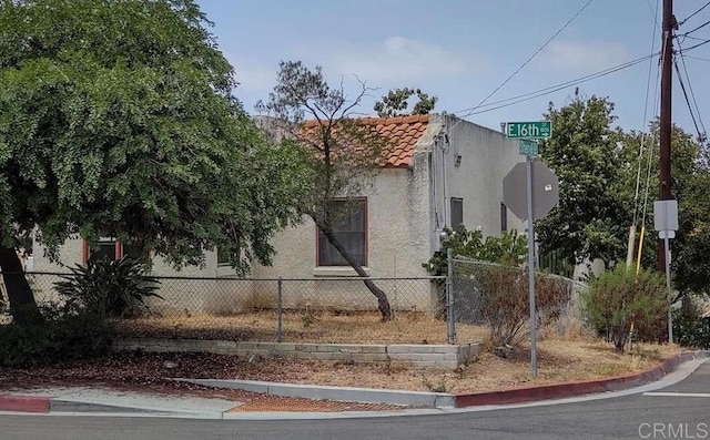 1843 E 16th St, National City, CA 91950 - view of side of home featuring a tile roof and stucco siding