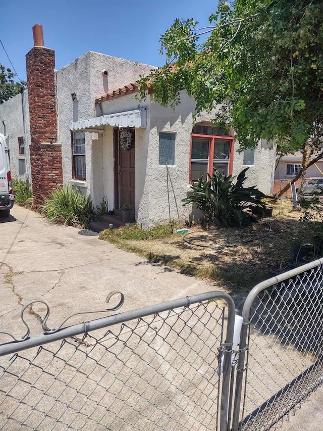 1843 E 16th St, National City, CA 91950 - view of front of property with stucco siding and a gate
