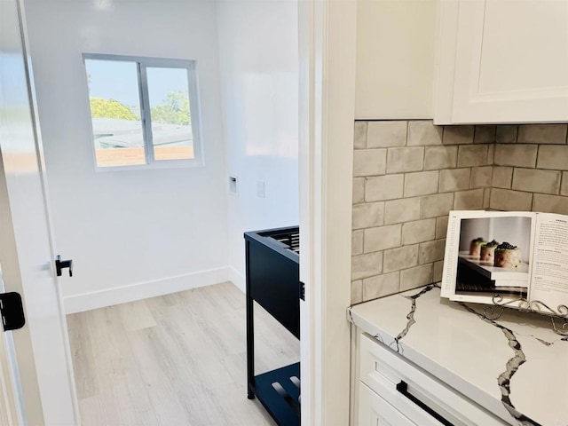 7118 Stanford Ave, La Mesa, CA 91942 - kitchen featuring white cabinets, light wood finished floors, light countertops, and tasteful backsplash