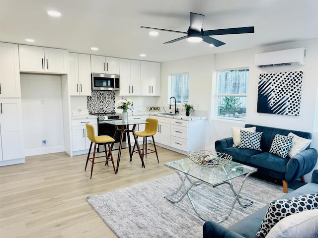 7118 Stanford Ave, La Mesa, CA 91942 - living room with a wall unit AC, a ceiling fan, light wood-style floors, and recessed lighting