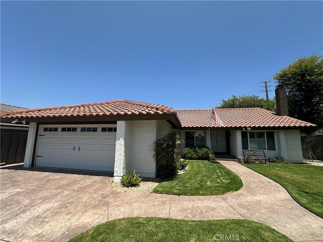 13191 Honeybee St, Moorpark, CA 93021 - view of front facade with stucco siding, an attached garage, driveway, a front lawn, and a tile roof