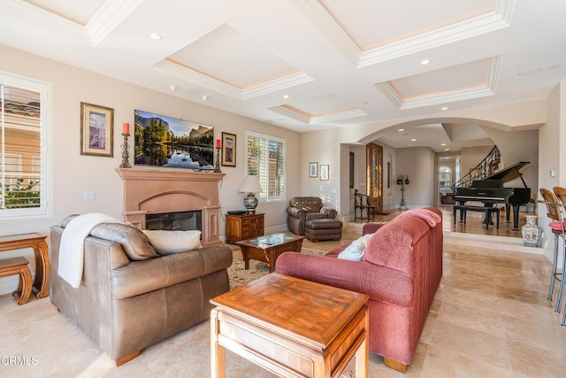 2110 Ravoli Dr, Oxnard, CA 93035 - living room featuring arched walkways, a glass covered fireplace, coffered ceiling, ornamental molding, and light tile patterned floors