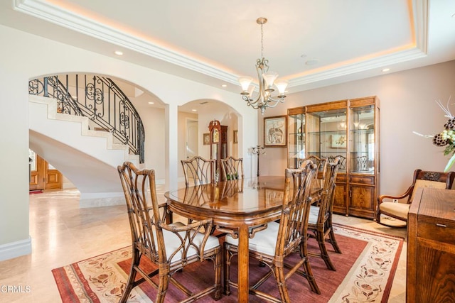 2110 Ravoli Dr, Oxnard, CA 93035 - dining room featuring a raised ceiling, arched walkways, recessed lighting, a chandelier, and stairs