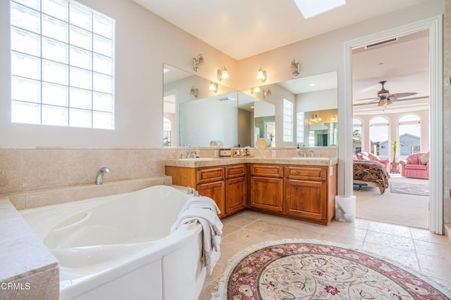 2110 Ravoli Dr, Oxnard, CA 93035 - full bathroom featuring double vanity, a bath, a ceiling fan, and connected bathroom