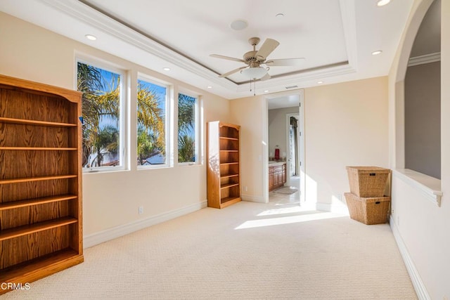 2110 Ravoli Dr, Oxnard, CA 93035 - carpeted spare room with arched walkways, a tray ceiling, ceiling fan, recessed lighting, and crown molding