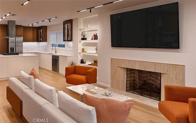 26144 Kenrose Cir, Calabasas, CA 91302 - living room featuring track lighting, light wood finished floors, and a tiled fireplace