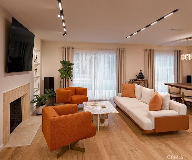 26144 Kenrose Cir, Calabasas, CA 91302 - living room with rail lighting, light wood-type flooring, and a fireplace
