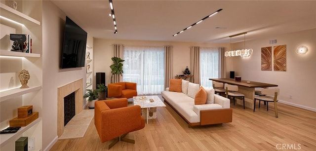 26144 Kenrose Cir, Calabasas, CA 91302 - living room with a fireplace, light wood-style flooring, and track lighting