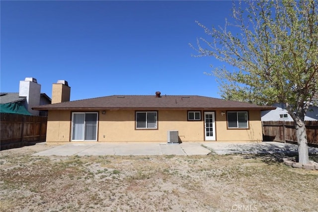 37334 55th St E, Palmdale, CA 93552 - rear view of property featuring a fenced backyard, stucco siding, a chimney, and a patio