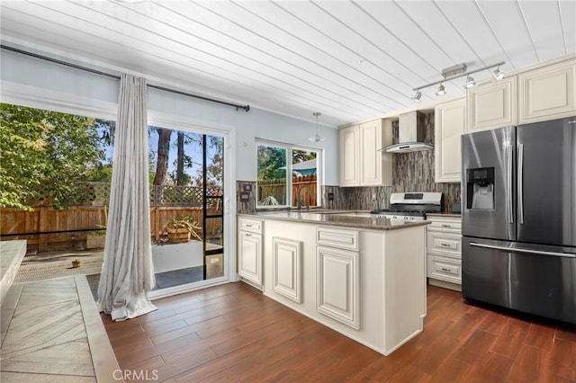 23711 Whale Cv, Laguna Niguel, CA 92677 - kitchen featuring appliances with stainless steel finishes, wall chimney range hood, a peninsula, backsplash, and dark wood finished floors