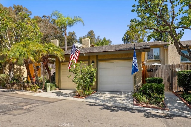 23711 Whale Cv, Laguna Niguel, CA 92677 - view of front of property with an attached garage, stucco siding, concrete driveway, and a chimney
