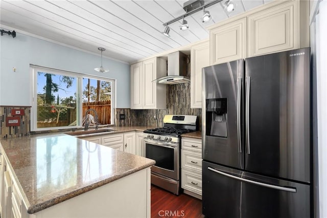 23711 Whale Cv, Laguna Niguel, CA 92677 - kitchen featuring stainless steel appliances, wall chimney range hood, a peninsula, backsplash, and stone countertops