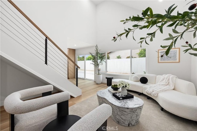 24091 Marathon St, Mission Viejo, CA 92691 - living room featuring stairway, wood finished floors, and a towering ceiling