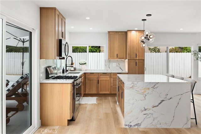 24091 Marathon St, Mission Viejo, CA 92691 - kitchen featuring double oven range, light wood finished floors, a kitchen island, light stone countertops, and recessed lighting