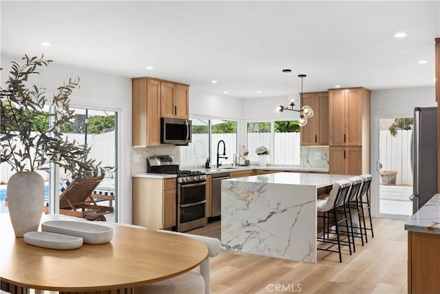 24091 Marathon St, Mission Viejo, CA 92691 - kitchen with stainless steel appliances, light wood-style floors, plenty of natural light, a center island, and recessed lighting