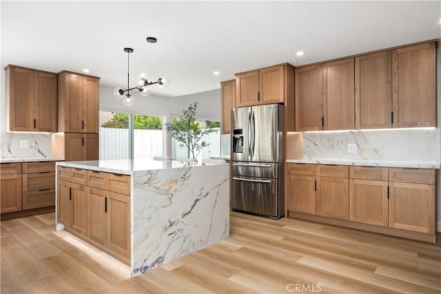 24091 Marathon St, Mission Viejo, CA 92691 - kitchen featuring stainless steel fridge, light wood finished floors, decorative backsplash, recessed lighting, and a chandelier