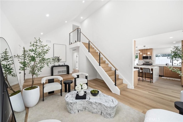 24091 Marathon St, Mission Viejo, CA 92691 - living area with high vaulted ceiling, recessed lighting, stairs, and light wood finished floors