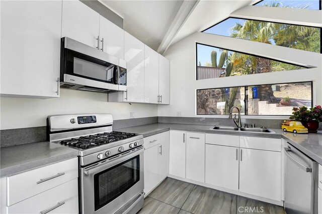 8742 Azul Dr, West Hills, CA 91304 - kitchen featuring appliances with stainless steel finishes, vaulted ceiling, and white cabinetry