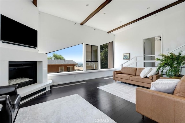 8742 Azul Dr, West Hills, CA 91304 - living area with wood finished floors, beam ceiling, and a fireplace with raised hearth