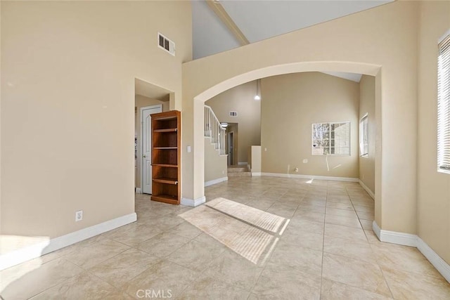 43939 Glenraven Rd, Lancaster, CA 93535 - empty room with arched walkways, stairway, high vaulted ceiling, and light tile patterned floors
