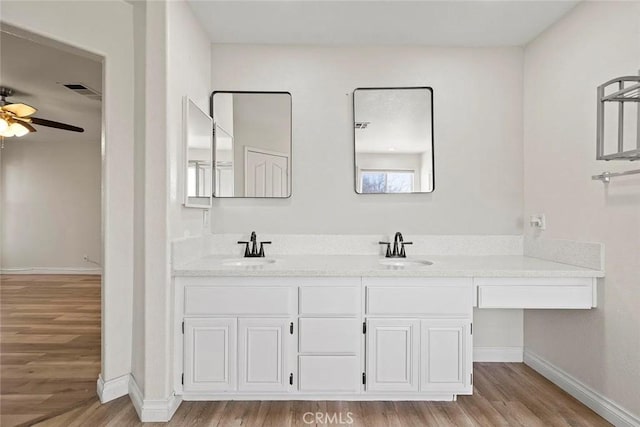 43939 Glenraven Rd, Lancaster, CA 93535 - full bath featuring wood finished floors, double vanity, and a ceiling fan
