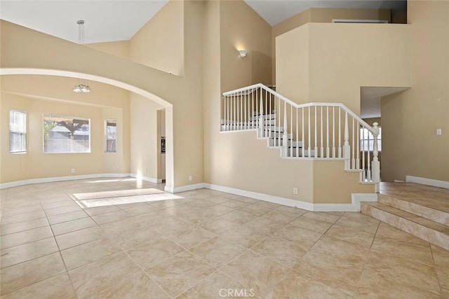 43939 Glenraven Rd, Lancaster, CA 93535 - tiled entrance foyer featuring stairs, a towering ceiling, and arched walkways