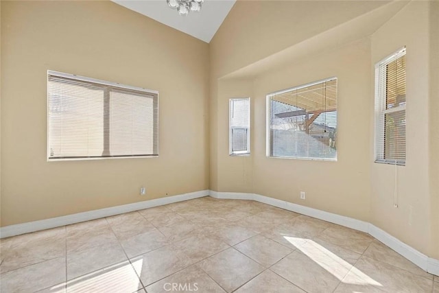 43939 Glenraven Rd, Lancaster, CA 93535 - tiled empty room featuring lofted ceiling and baseboards