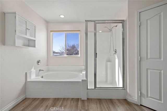 43939 Glenraven Rd, Lancaster, CA 93535 - full bath with a stall shower, a garden tub, and wood finished floors