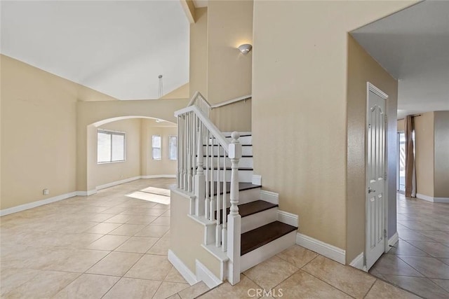 43939 Glenraven Rd, Lancaster, CA 93535 - stairway with arched walkways, tile patterned flooring, and vaulted ceiling