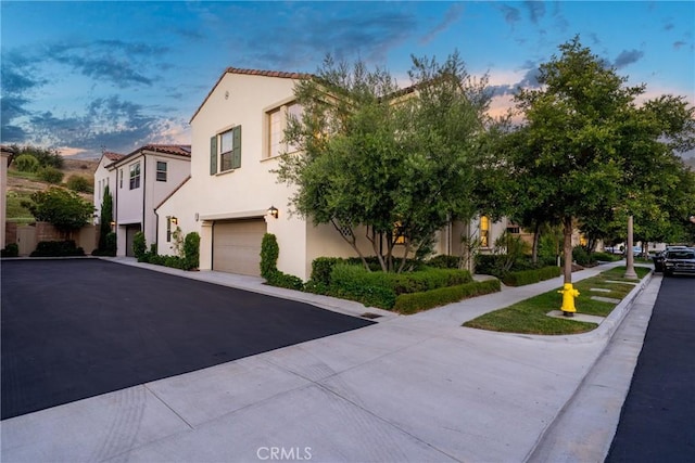 113 Soaring Eagle, Irvine, CA 92618 - view of front of house with an attached garage, stucco siding, driveway, and a tiled roof