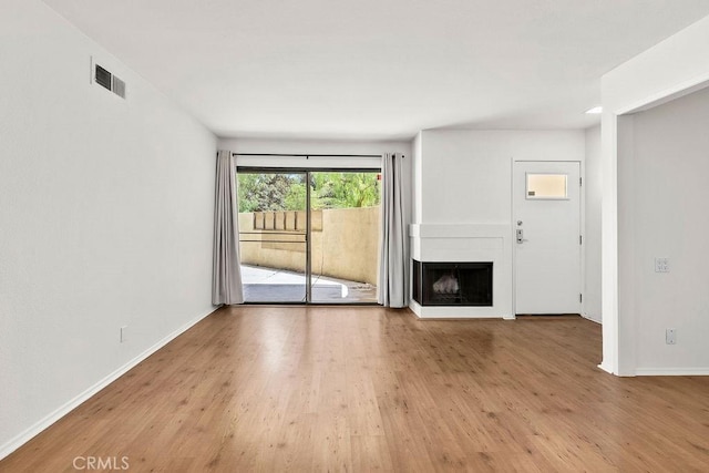 13104 Glen Ct Unit 7, Chino Hills, CA 91709 - unfurnished living room featuring wood finished floors and a fireplace