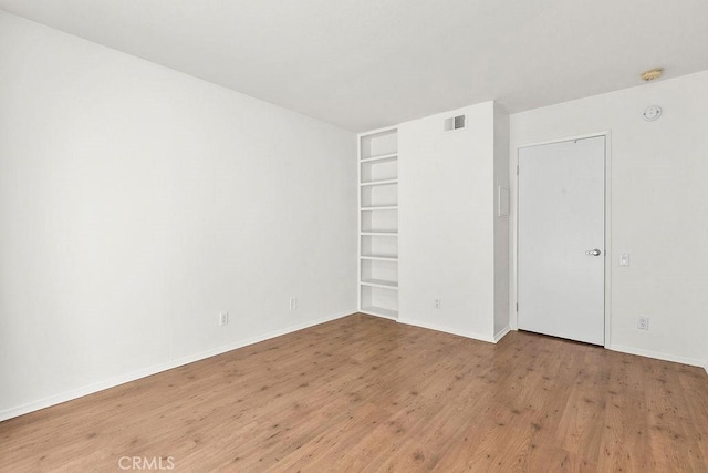 13104 Glen Ct Unit 7, Chino Hills, CA 91709 - spare room with built in shelves and wood finished floors
