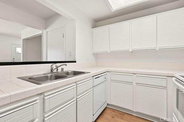 13104 Glen Ct Unit 7, Chino Hills, CA 91709 - kitchen featuring white dishwasher, white cabinetry, light wood finished floors, and tile counters
