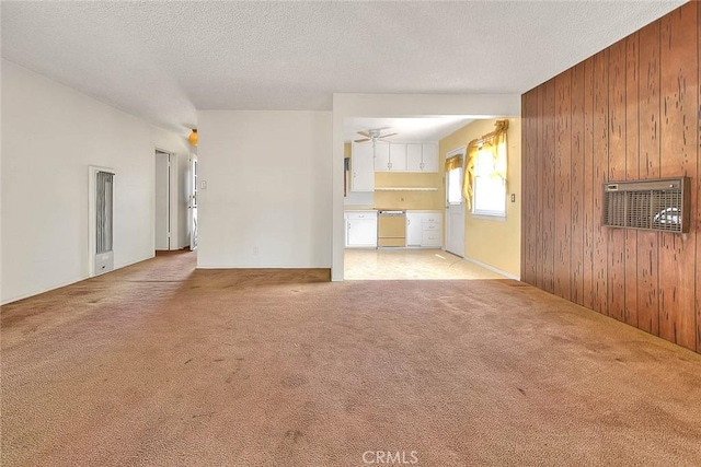833 W Orangepath St, Glendora, CA 91741 - unfurnished living room with wooden walls, carpet flooring, a textured ceiling, and ceiling fan