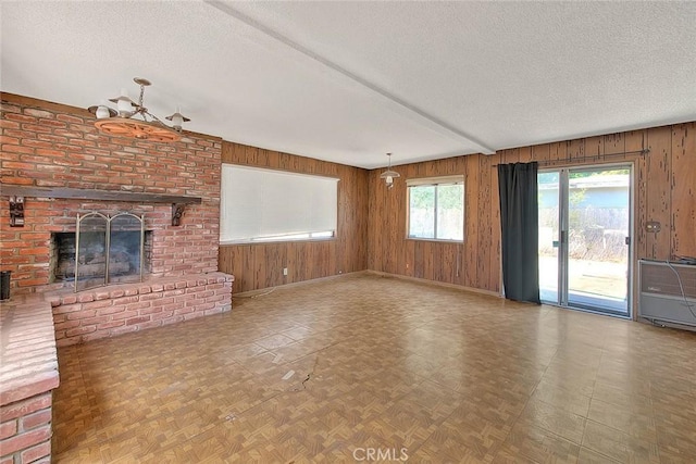 833 W Orangepath St, Glendora, CA 91741 - unfurnished living room with a textured ceiling, wooden walls, and a fireplace