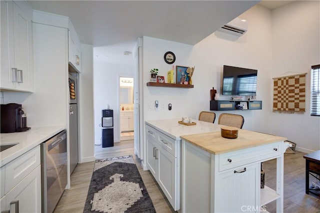 5926 Gran Paseo Way, Atascadero, CA 93422 - kitchen featuring stainless steel dishwasher, light wood finished floors, a wall mounted AC, white cabinets, and open shelves
