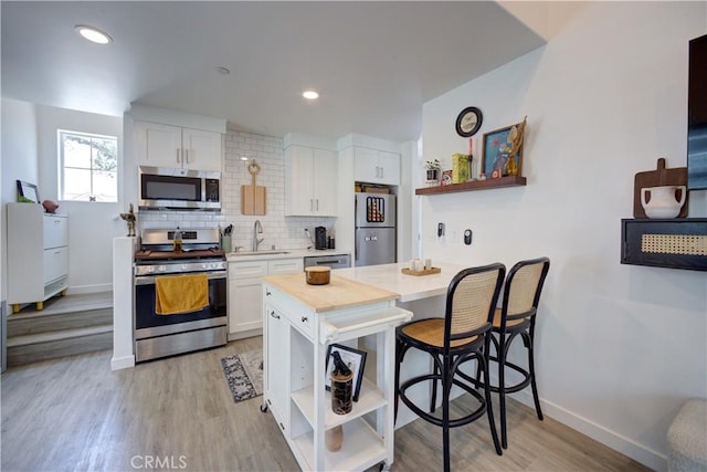 5926 Gran Paseo Way, Atascadero, CA 93422 - kitchen with stainless steel appliances, open shelves, white cabinets, and recessed lighting