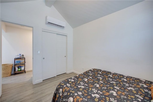 5926 Gran Paseo Way, Atascadero, CA 93422 - bedroom with a wall mounted air conditioner, light wood-style flooring, lofted ceiling, and a closet