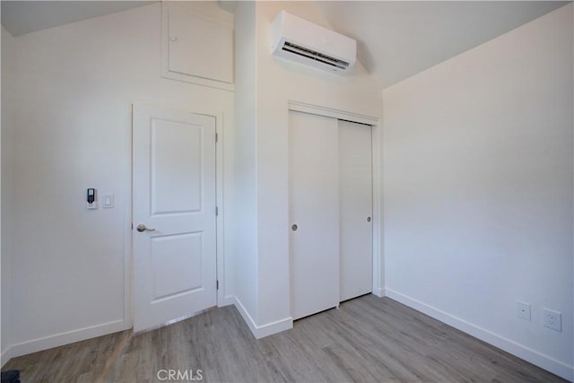 5926 Gran Paseo Way, Atascadero, CA 93422 - unfurnished bedroom featuring a wall mounted air conditioner, light wood-style floors, and a closet