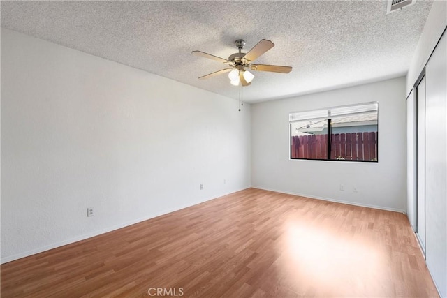 41384 Collegian Way, Hemet, CA 92544 - spare room with light wood finished floors, ceiling fan, and a textured ceiling