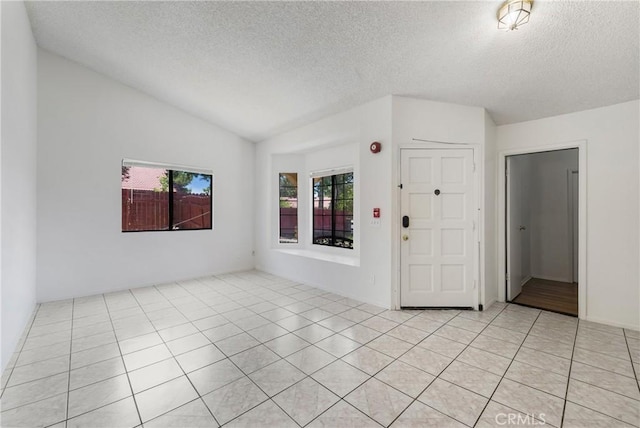 41384 Collegian Way, Hemet, CA 92544 - spare room with lofted ceiling, a textured ceiling, and light tile patterned floors
