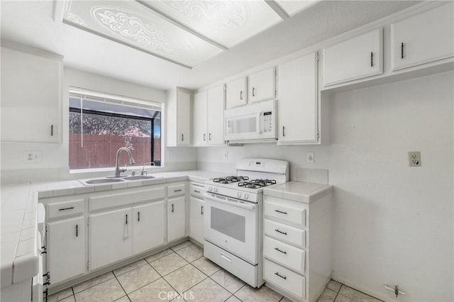 41384 Collegian Way, Hemet, CA 92544 - kitchen with white appliances, tile counters, white cabinets, and light tile patterned flooring