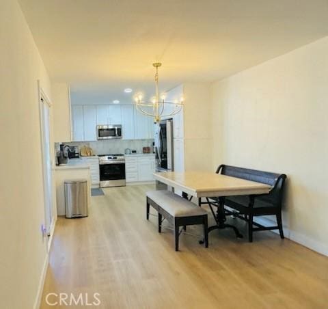 1308 Dixon Ct, Chula Vista, CA 91911 - dining area featuring a chandelier and light wood-type flooring
