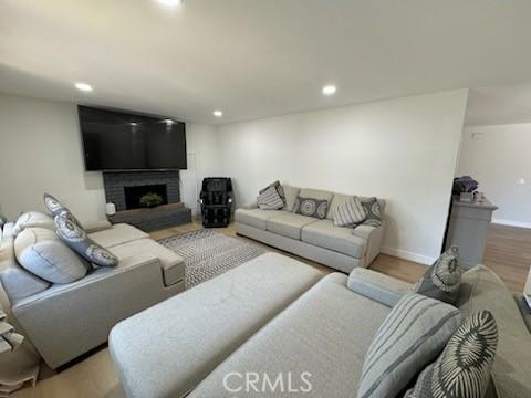 1308 Dixon Ct, Chula Vista, CA 91911 - living room featuring a brick fireplace, recessed lighting, and wood finished floors