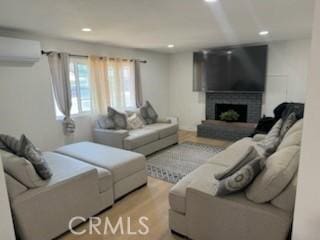 1308 Dixon Ct, Chula Vista, CA 91911 - living room with a wall mounted air conditioner, recessed lighting, light wood-style flooring, and a brick fireplace